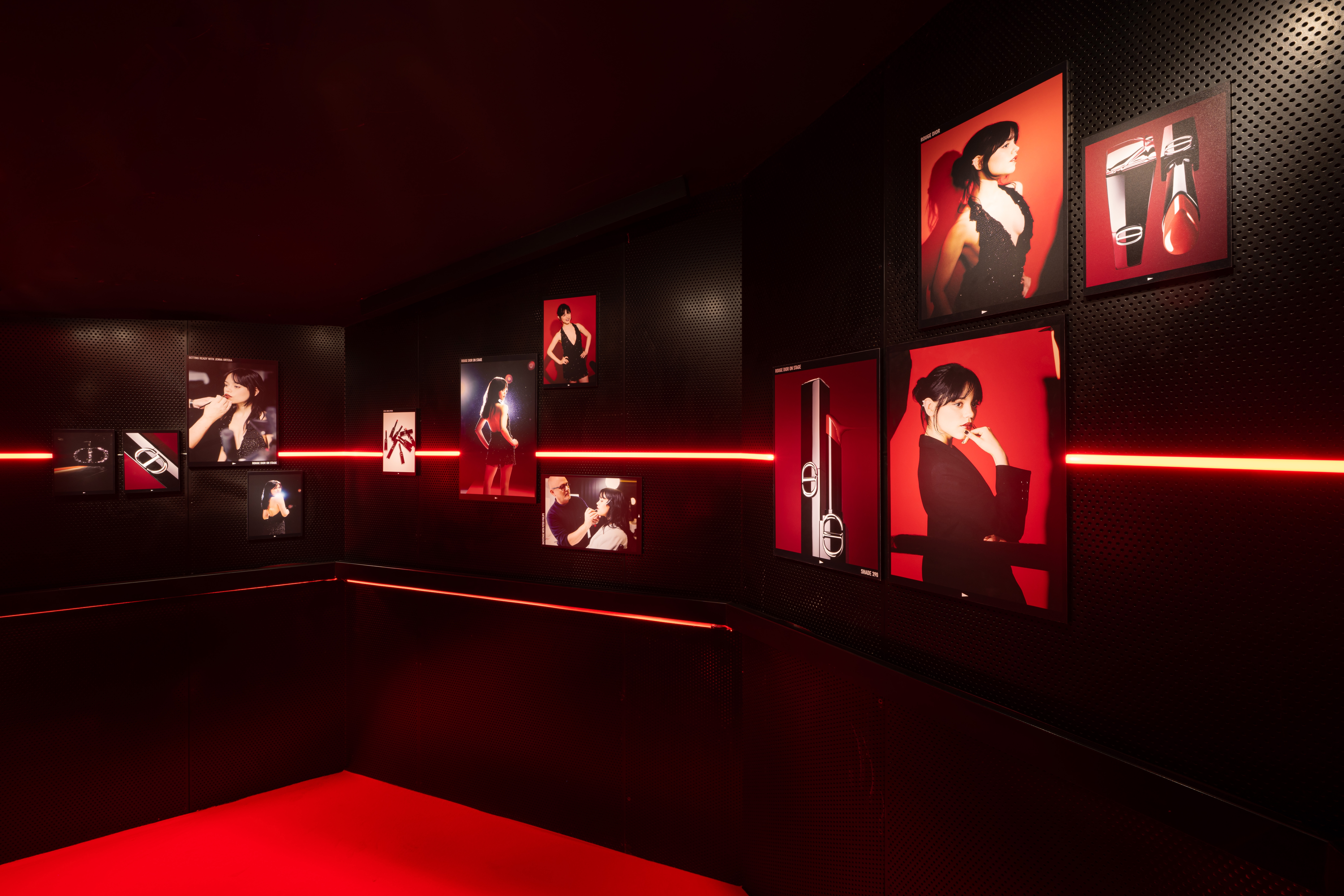 Jenna Ortega portraits for Rouge Dior On Stage campaignes and lipsticks displayed on a staircase wall at the Silencio Club in Paris.