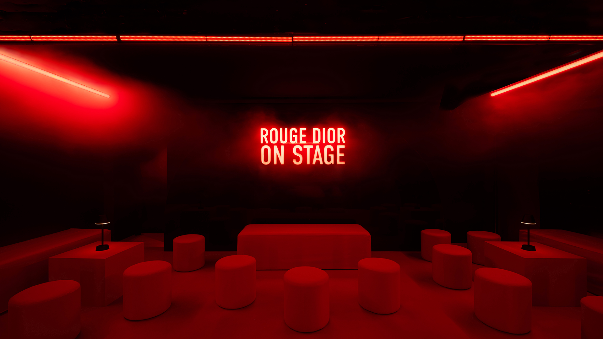 Red lounge with Rouge Dior On Stage neon sign at Silencio Club in Paris.
