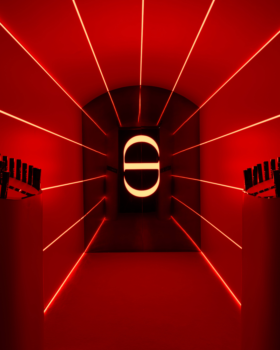 Red content room with neon installation and Dior Rouge On Stage lipsticks displays at Silencio Club in Paris.