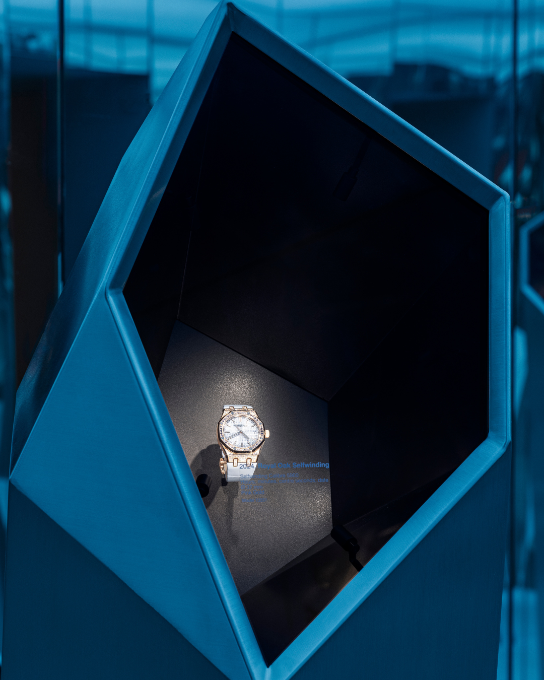 Close-up of metallic crystal structure displaying an Audemars Piguet watch at Shaping Materials exhibition in Milan.