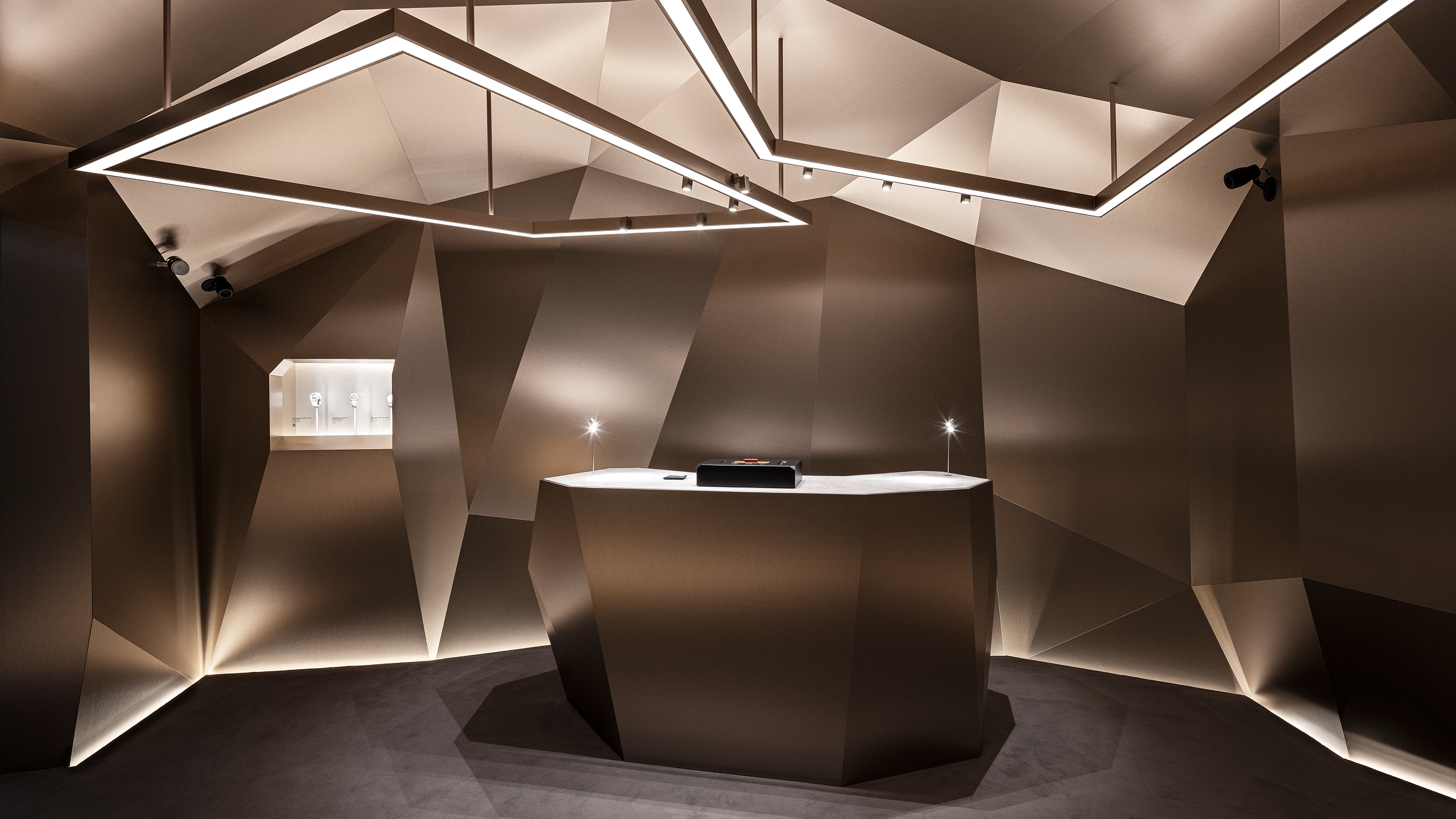 Watch display counter with Audemars Piguet watches in glass vitrines inside a gold room at the Shaping Materials exhibition in Milan.