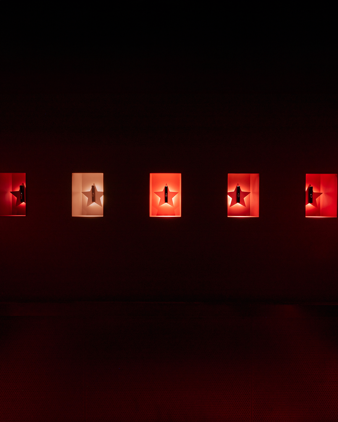 Star-shaped wall alcoves displaying Rouge Dior On Stage lipsticks at Silencio Club in Paris.