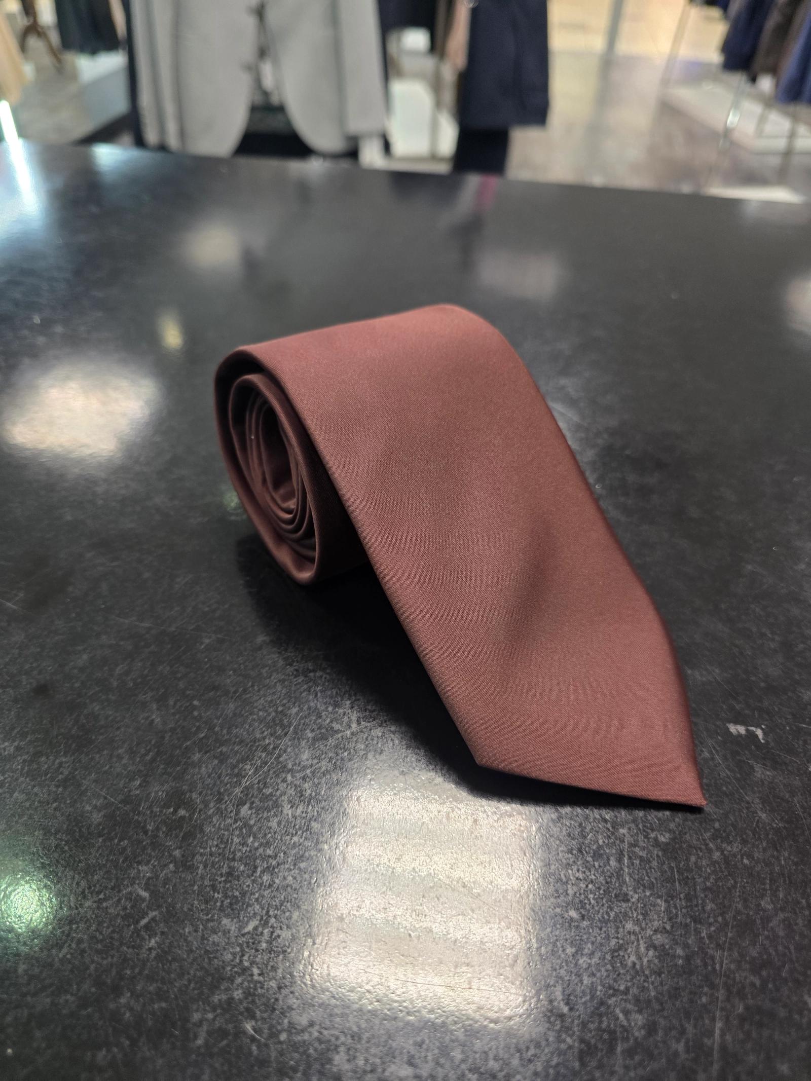 Viento burgundy satin tie, rolled view on dark counter