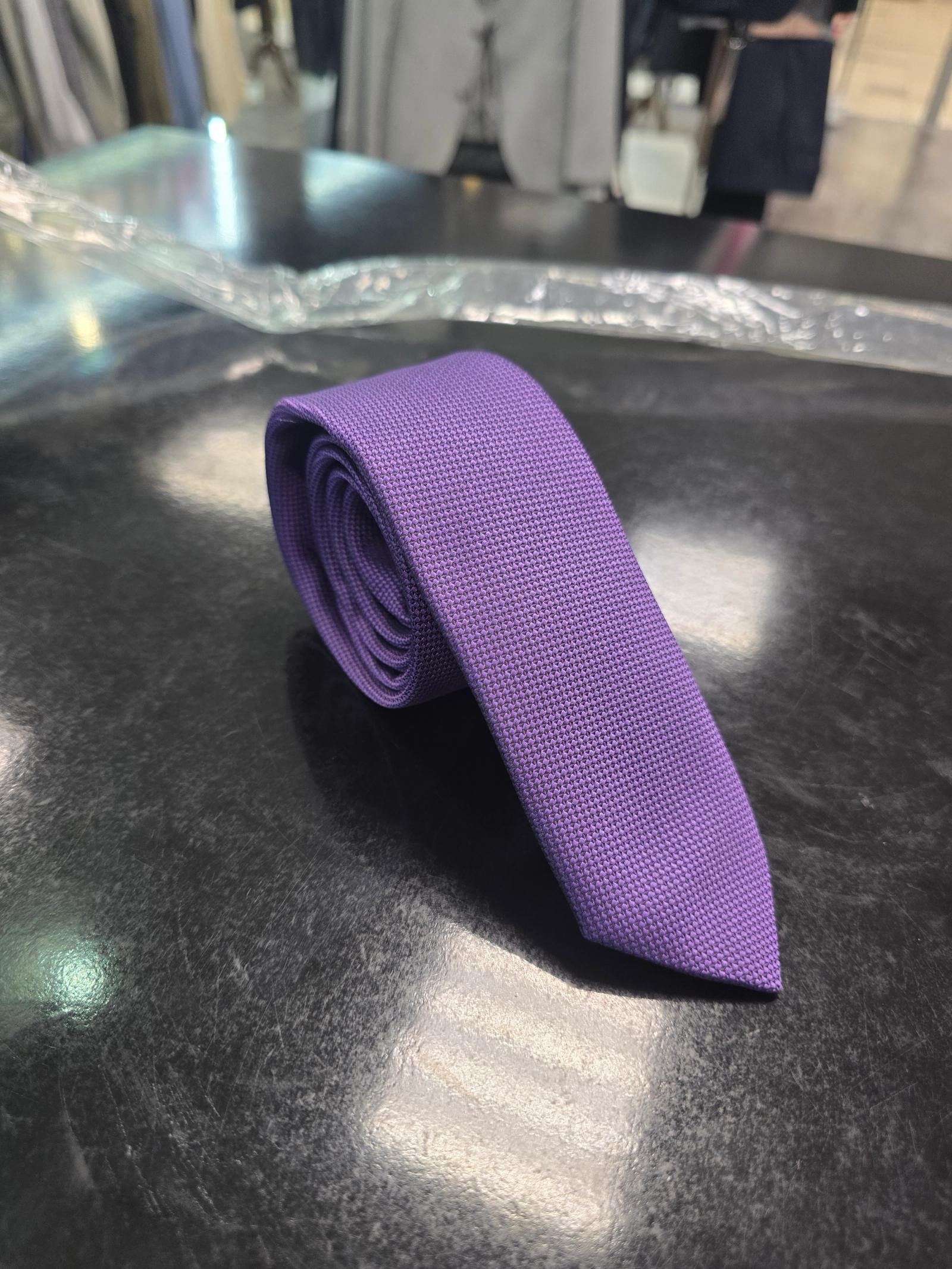 Viento textured purple tie, vertical full-length view on dark counter