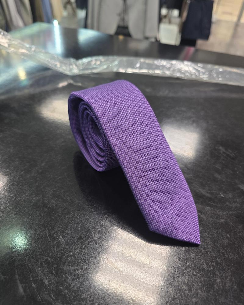Viento textured purple tie, vertical full-length view on dark counter