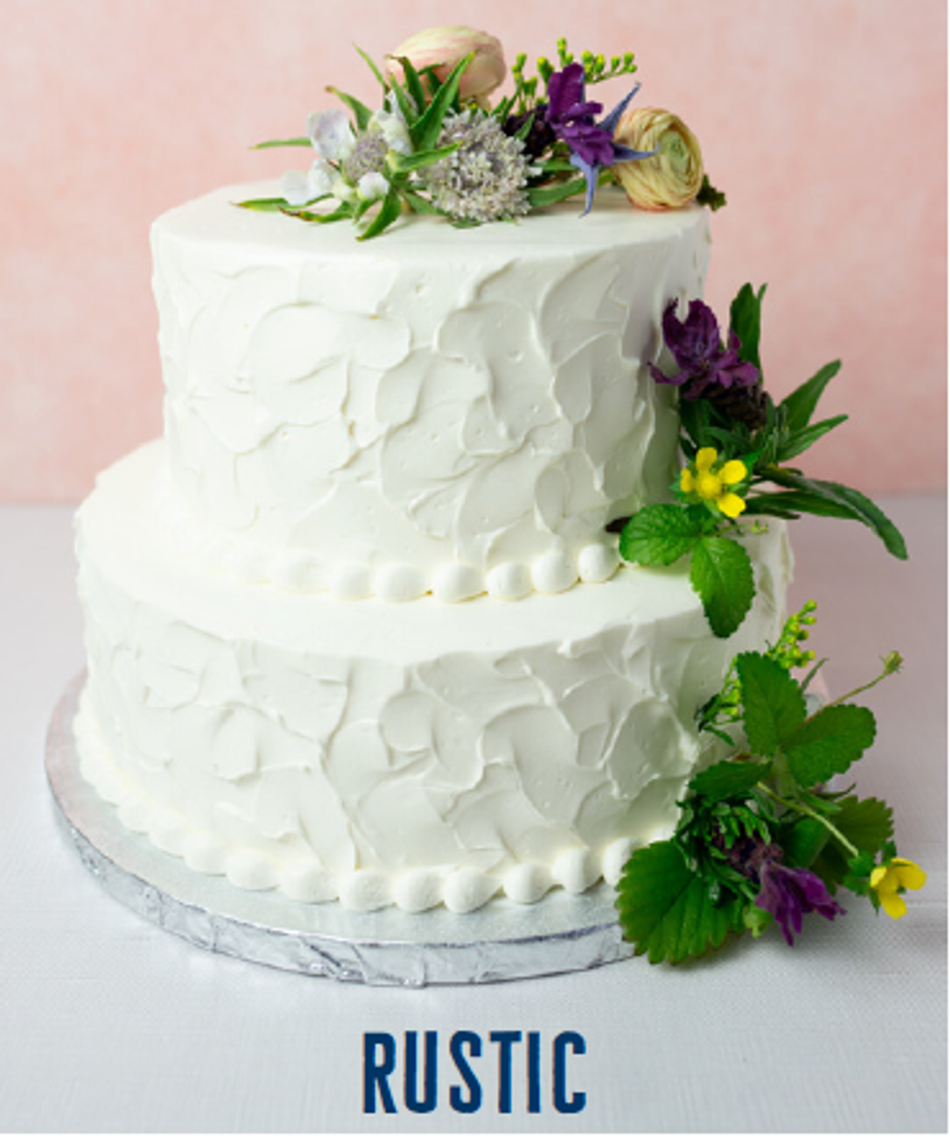 two-tier wedding cake featuring textured buttercream design and fresh flowers