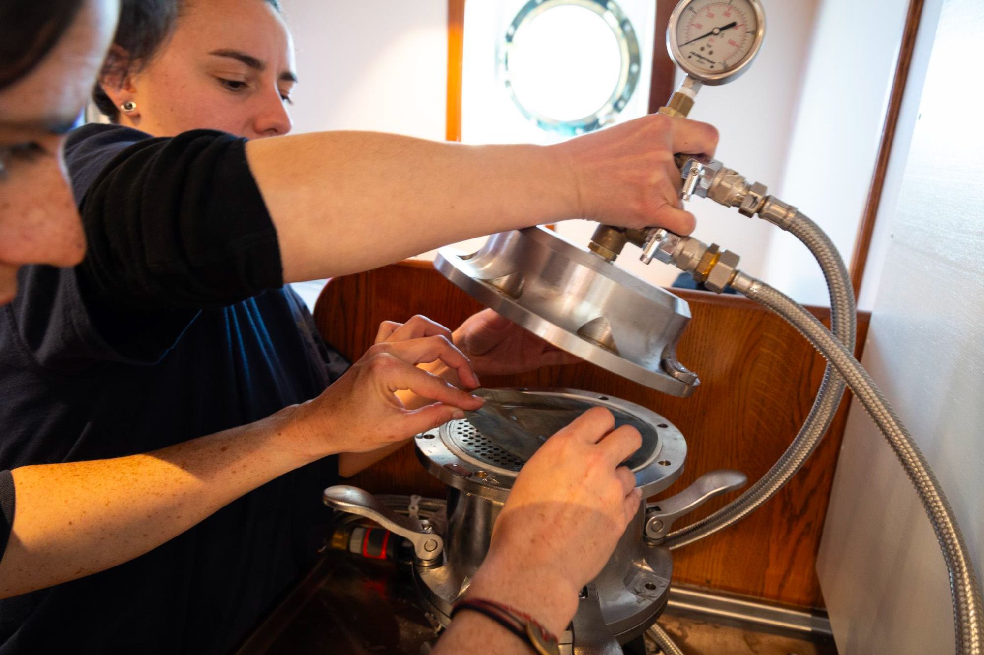 Lucie Cassarino and Natacha Fabregas filtering microplastics samples. Photo: One Ocean Expedition