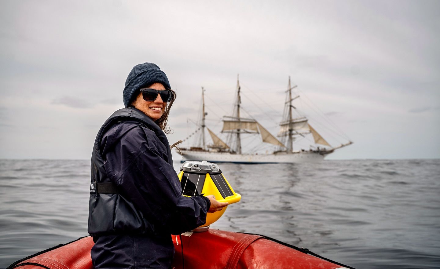 Research coordinator Natacha Fabregas release a buoy that will drift in the ocean and measure wave height. Photo: Malin Kvamme 