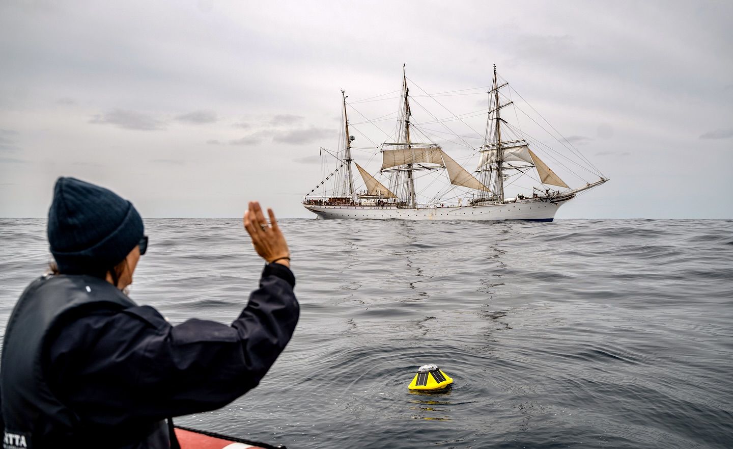 Research coordinator Natacha Fabregas release a buoy that will drift in the ocean and measure wave height. Photo: Malin Kvamme 