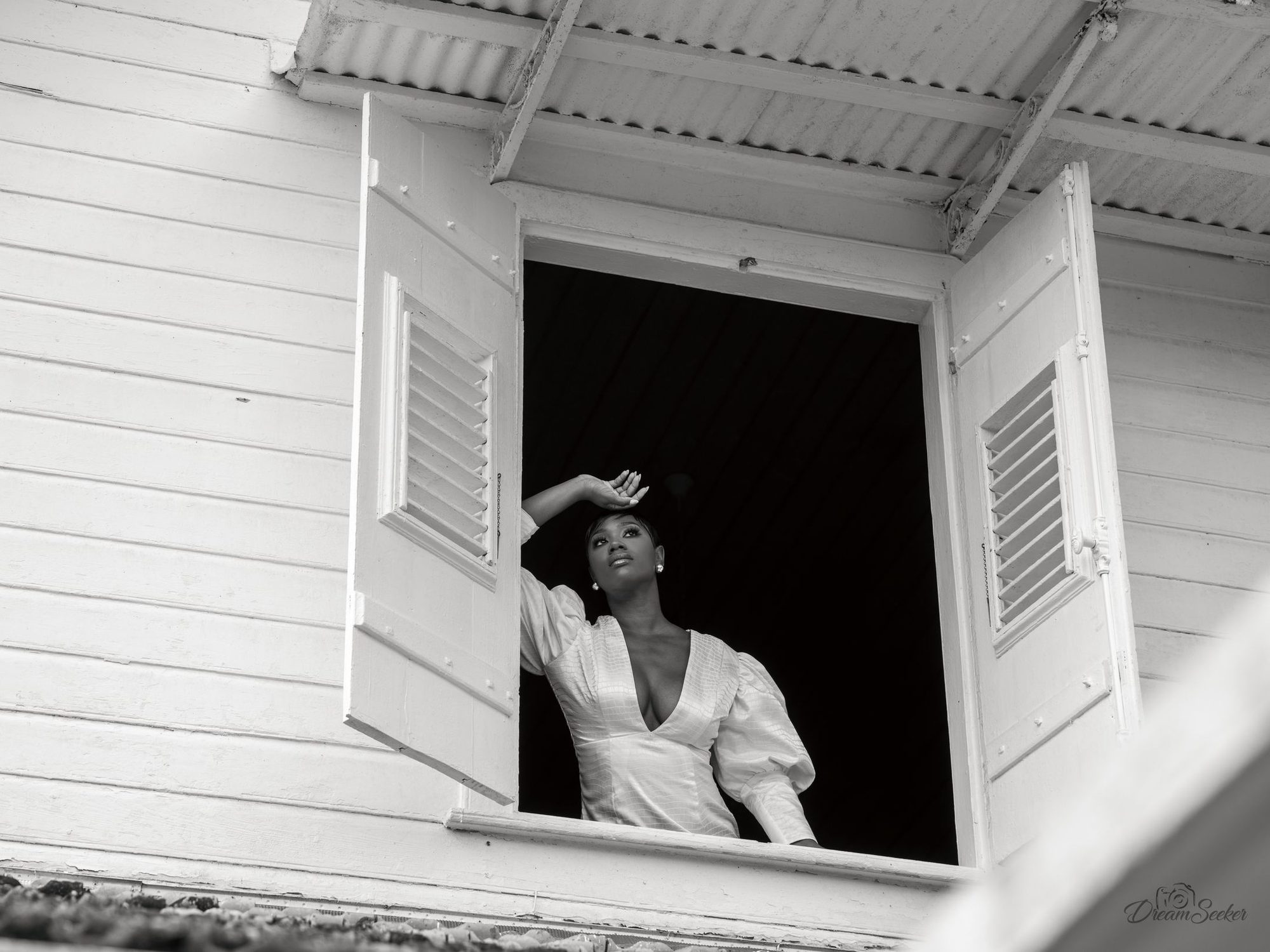 Femme à la fenêtre d’une maison créole, noir et blanc