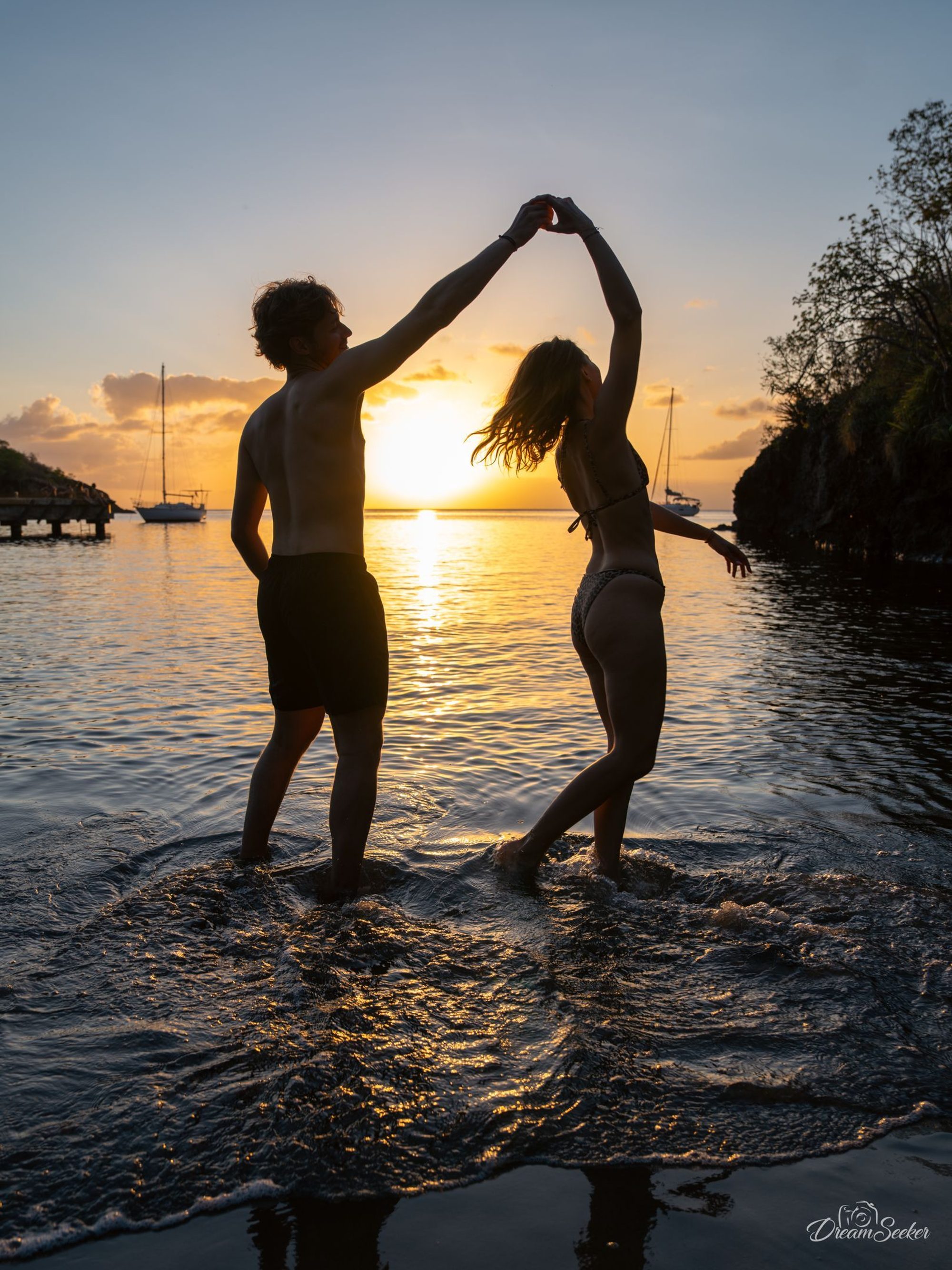 Couple dansant dans l’eau au coucher du soleil