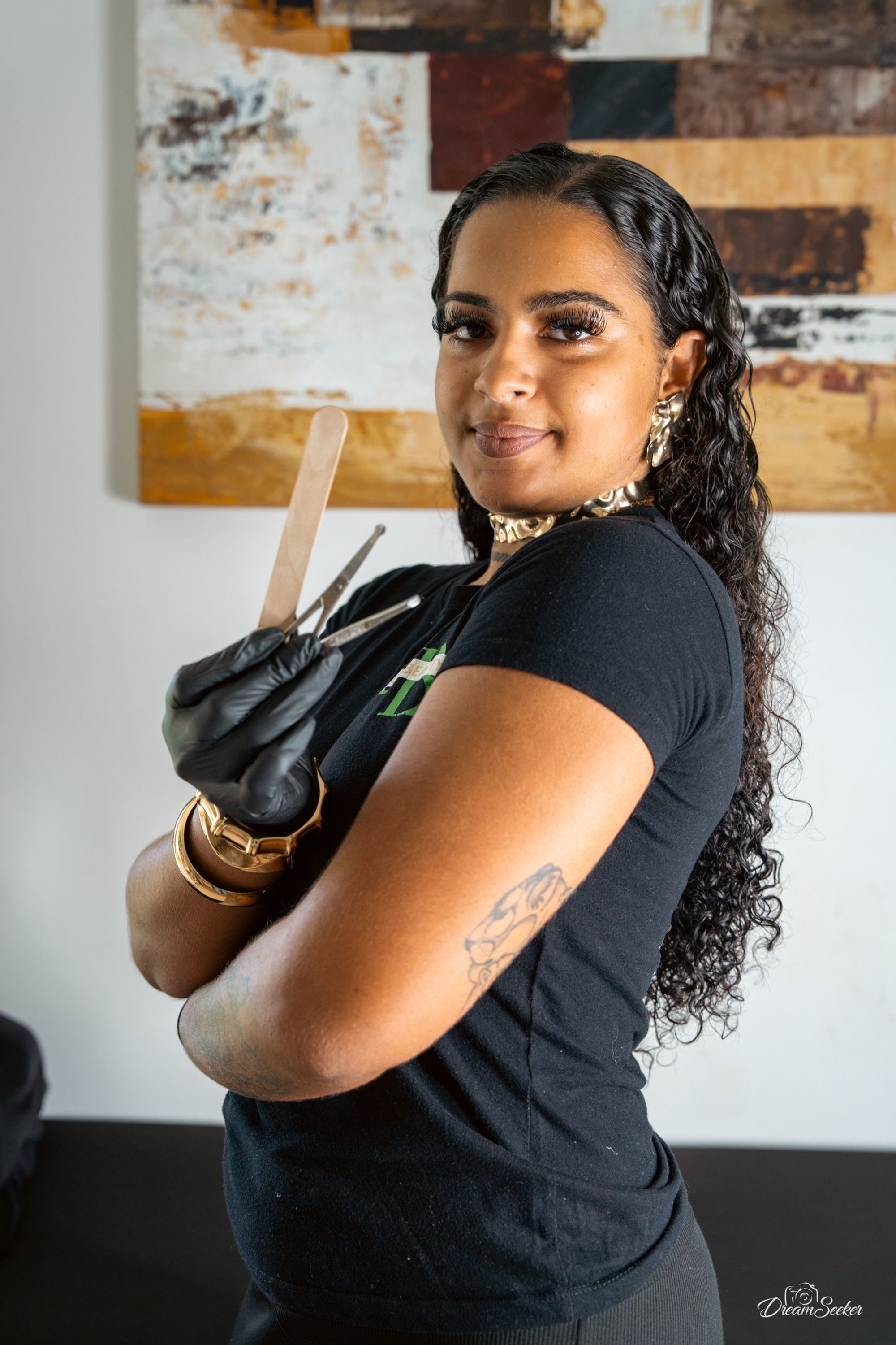 Femme bras croisés dans son atelier, gant à la main