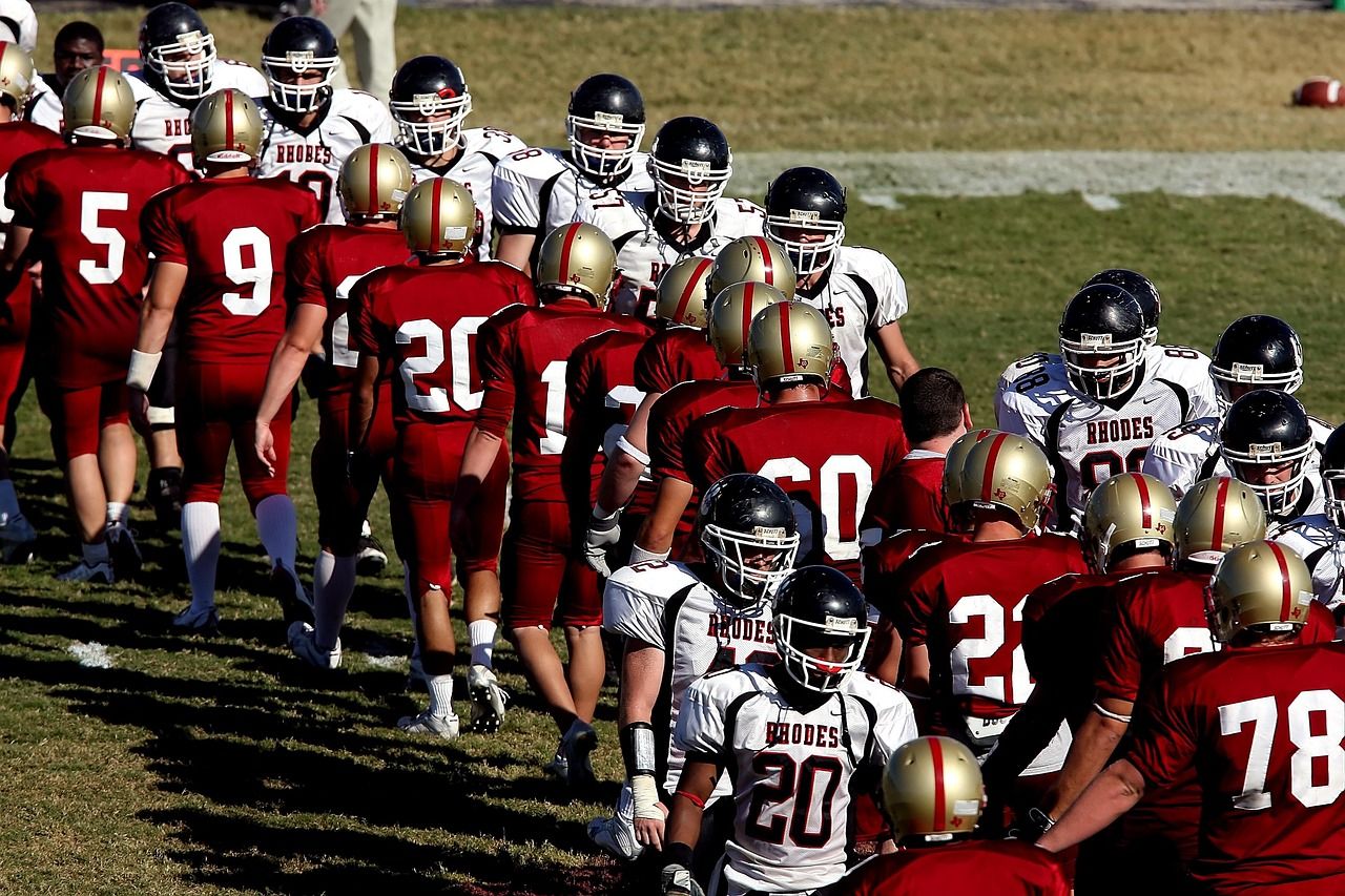 Referee tossing coin during college football overtime coin toss.