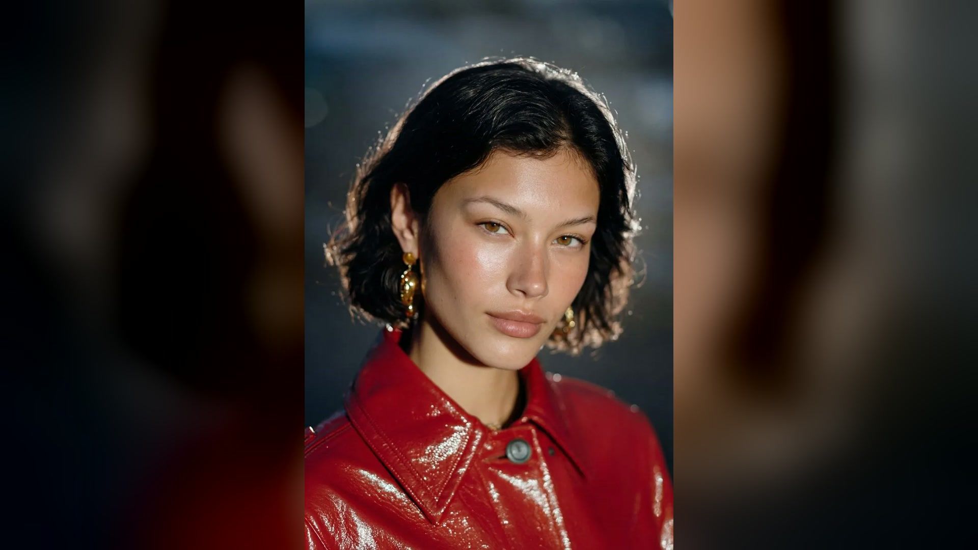 retro 90s close-up studio portrait with direct light and a red vinyl jacket