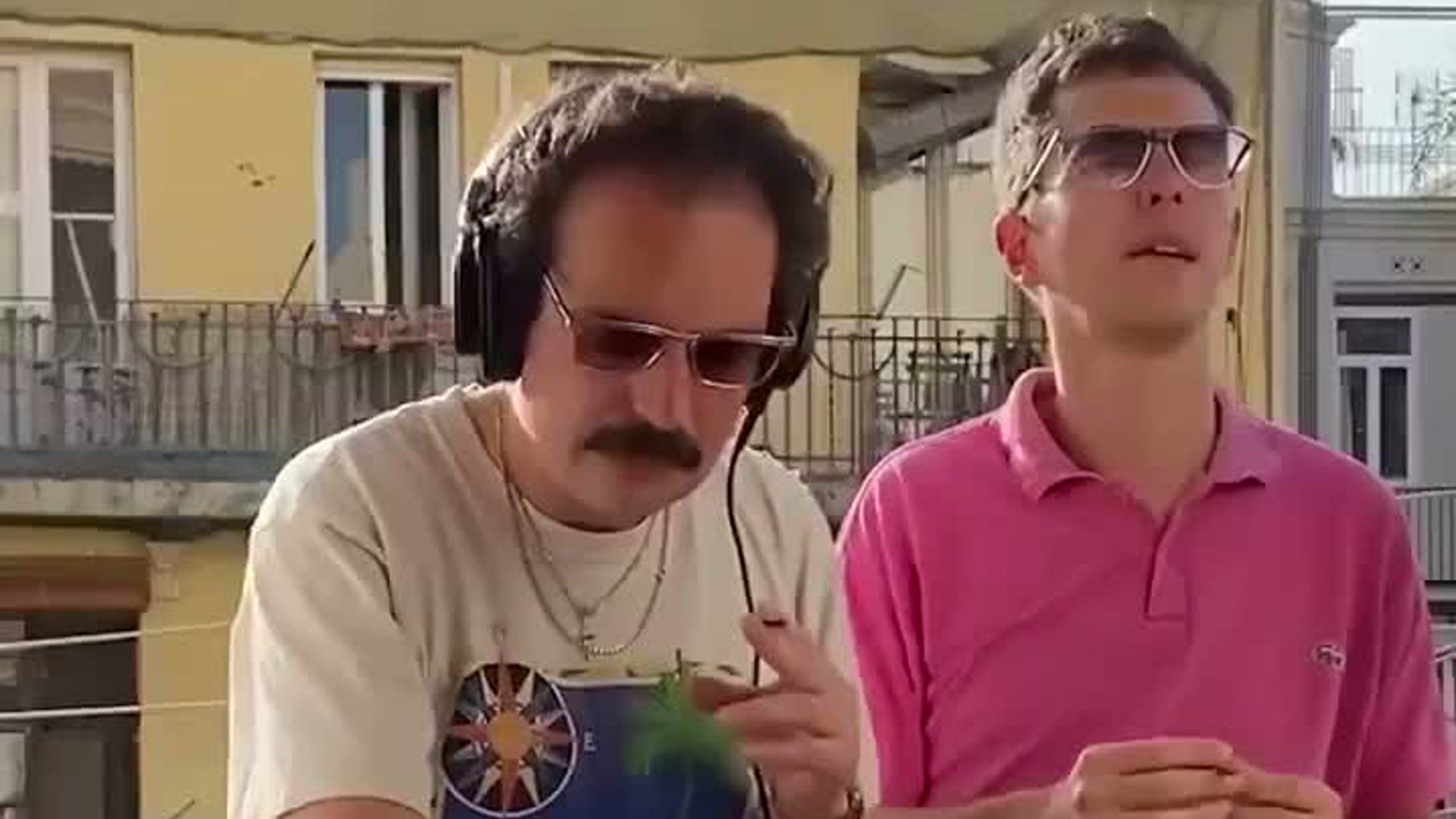 two adult performers making a retro balcony dance video