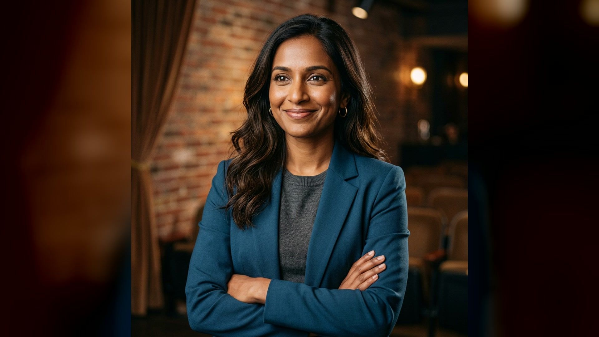 Professional comedian headshot with a warm expression in a softly lit venue