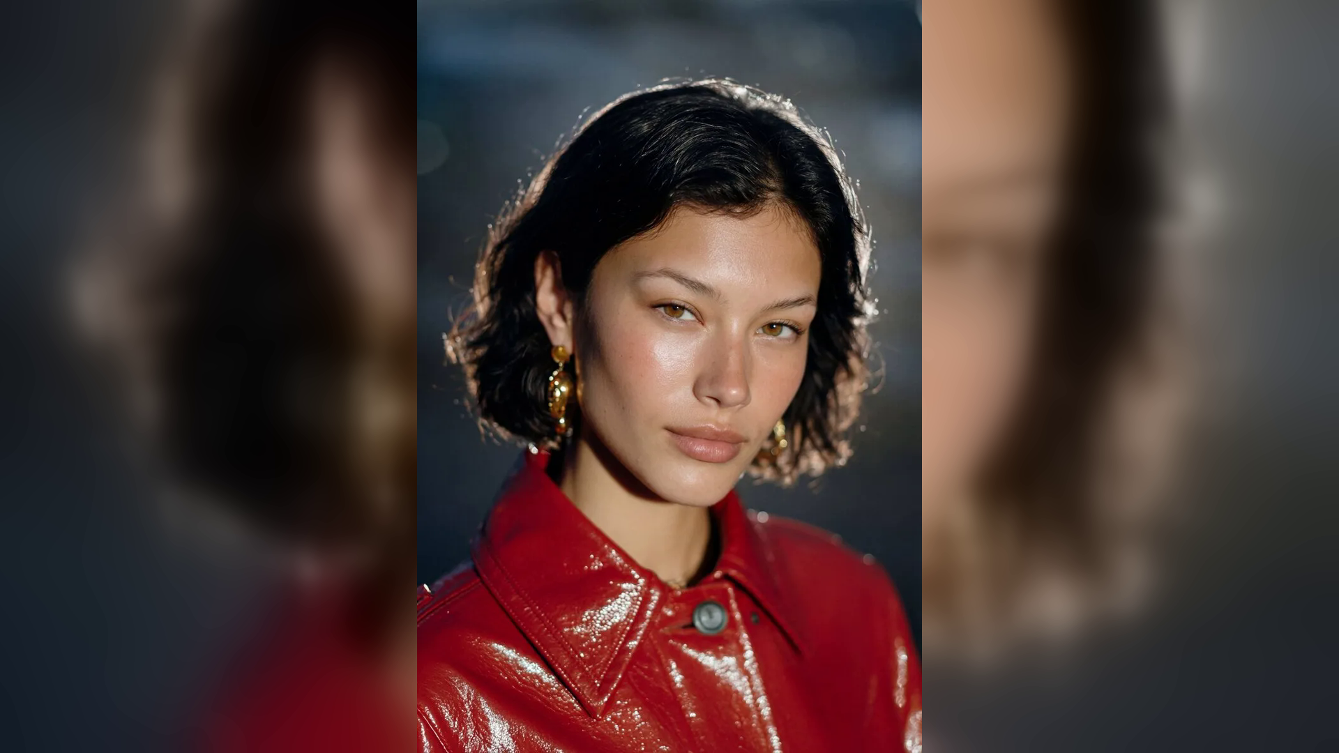 1980s-inspired beauty portrait in a glossy red jacket with dramatic studio lighting