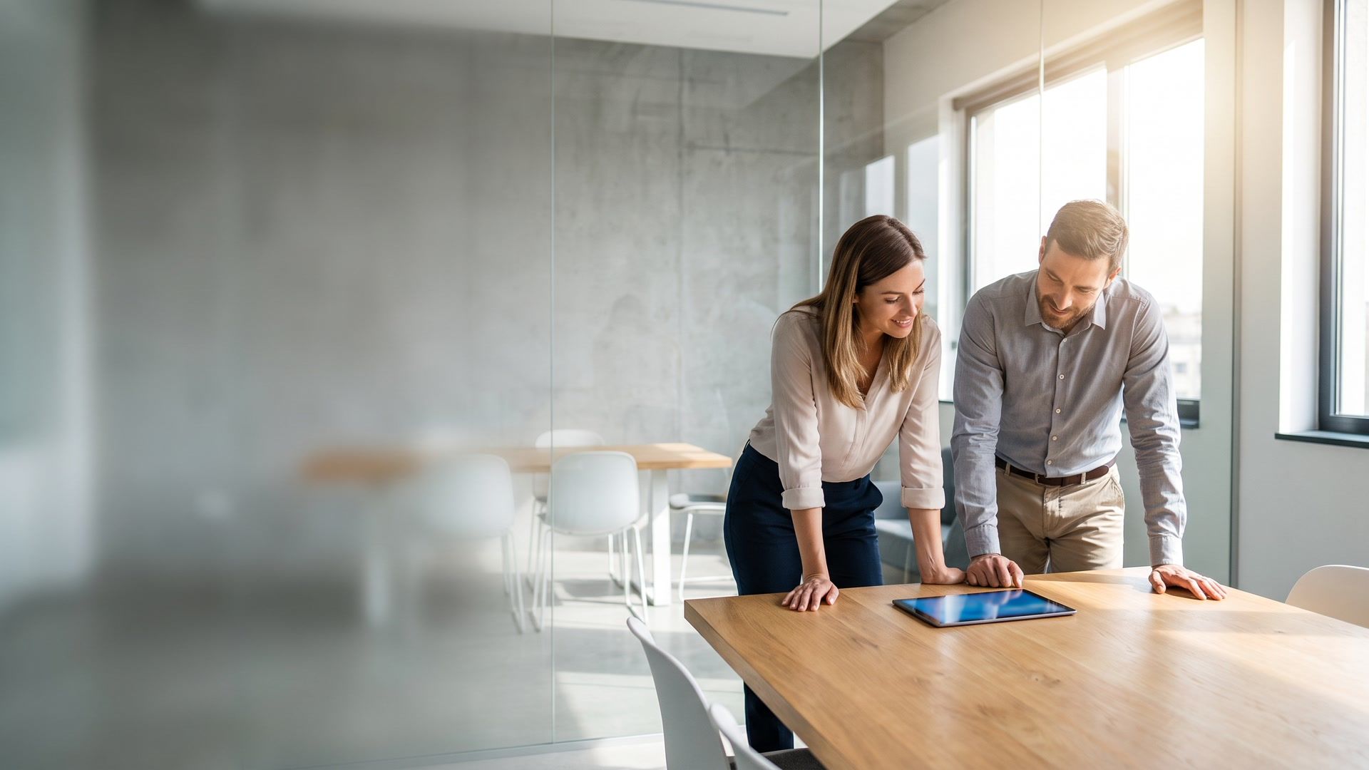 two colleagues reviewing a prototype together in a bright modern meeting room