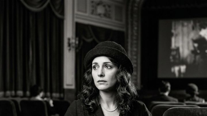black-and-white silent-film-inspired portrait in a vintage cinema