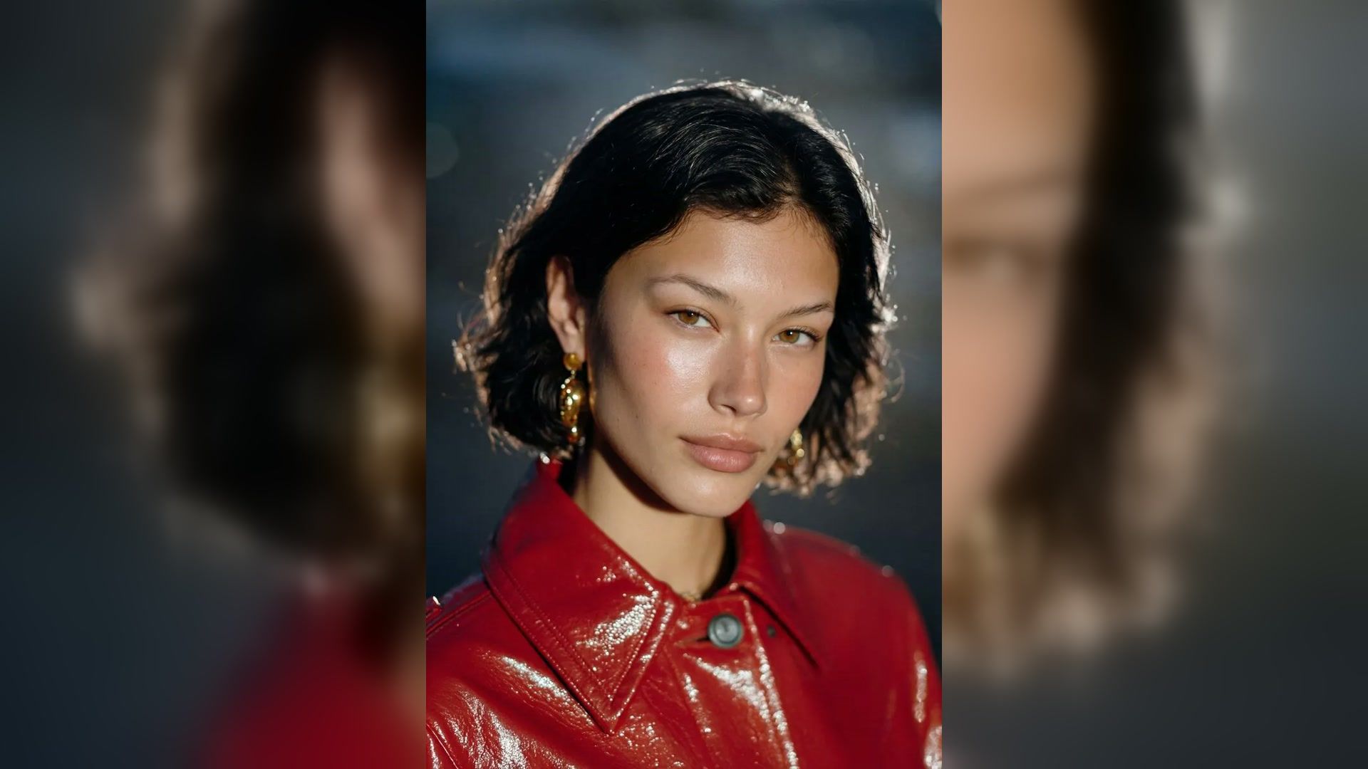 editorial portrait in a red jacket with studio lighting