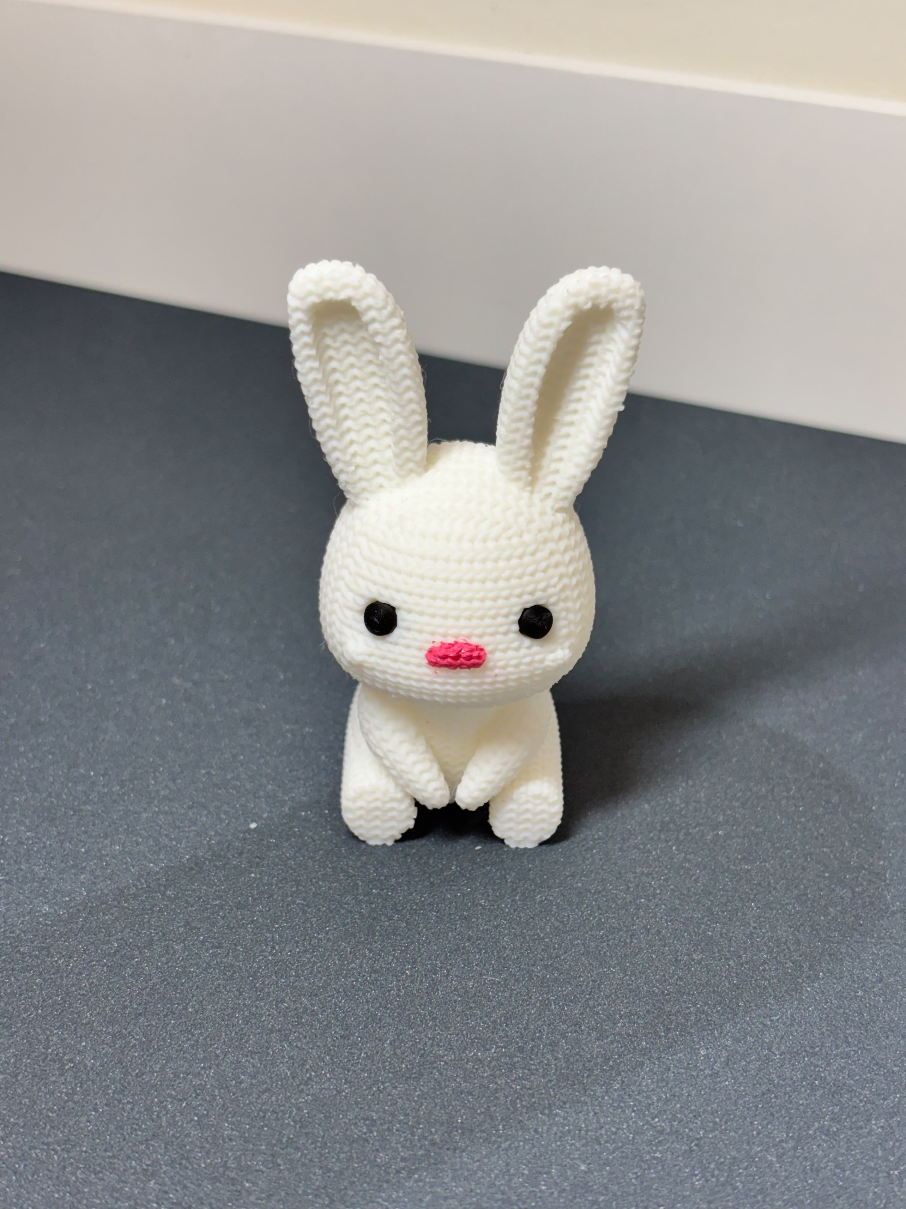 Cute 3D printed white bunny rabbit miniature figurine on desk