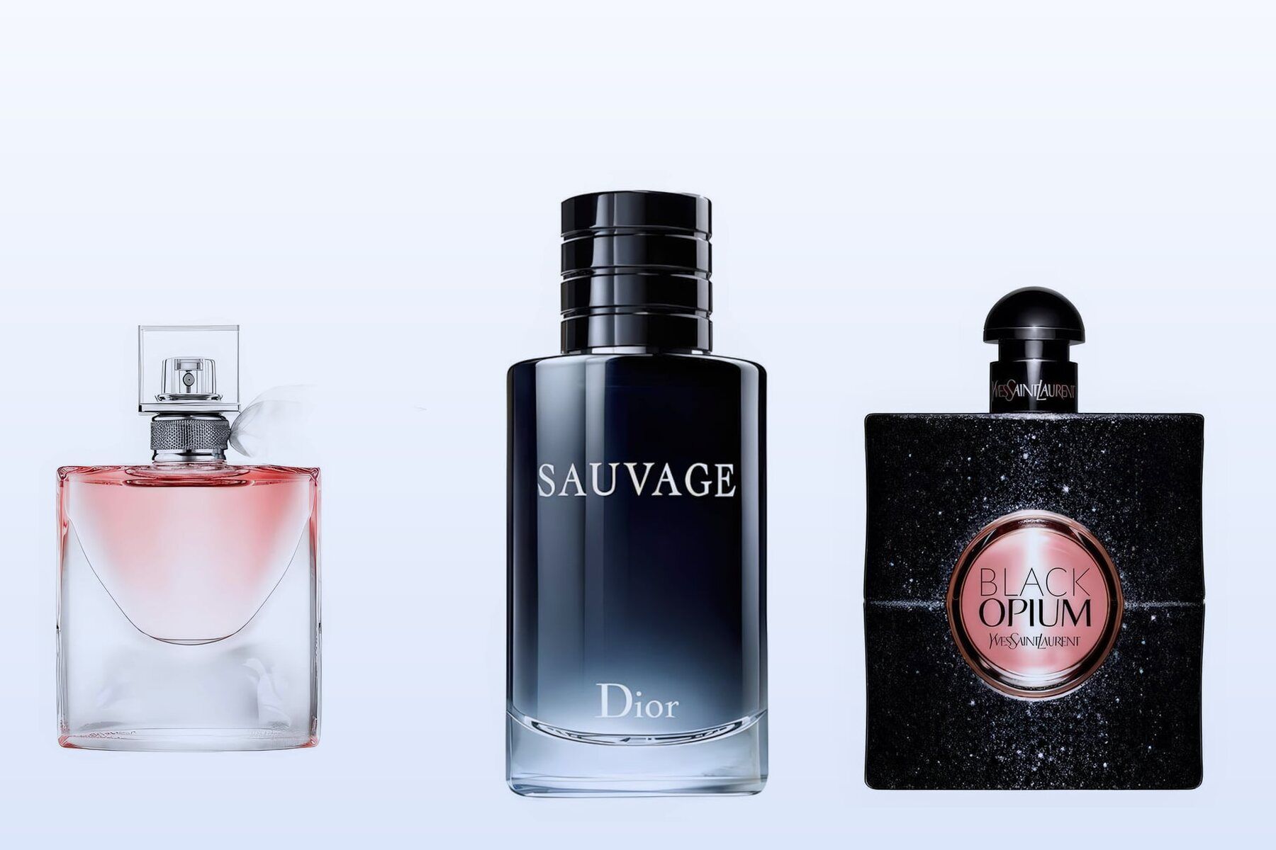 Three fragrance bottles, La Vie Est Belle, Sauvage and Black Opium, on a pale blue background