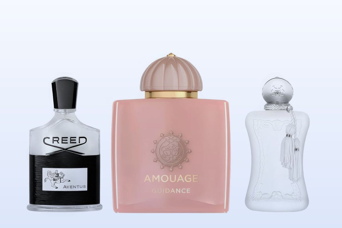 Three perfume bottles, Aventus, Guidance and Valaya, on a pale blue background
