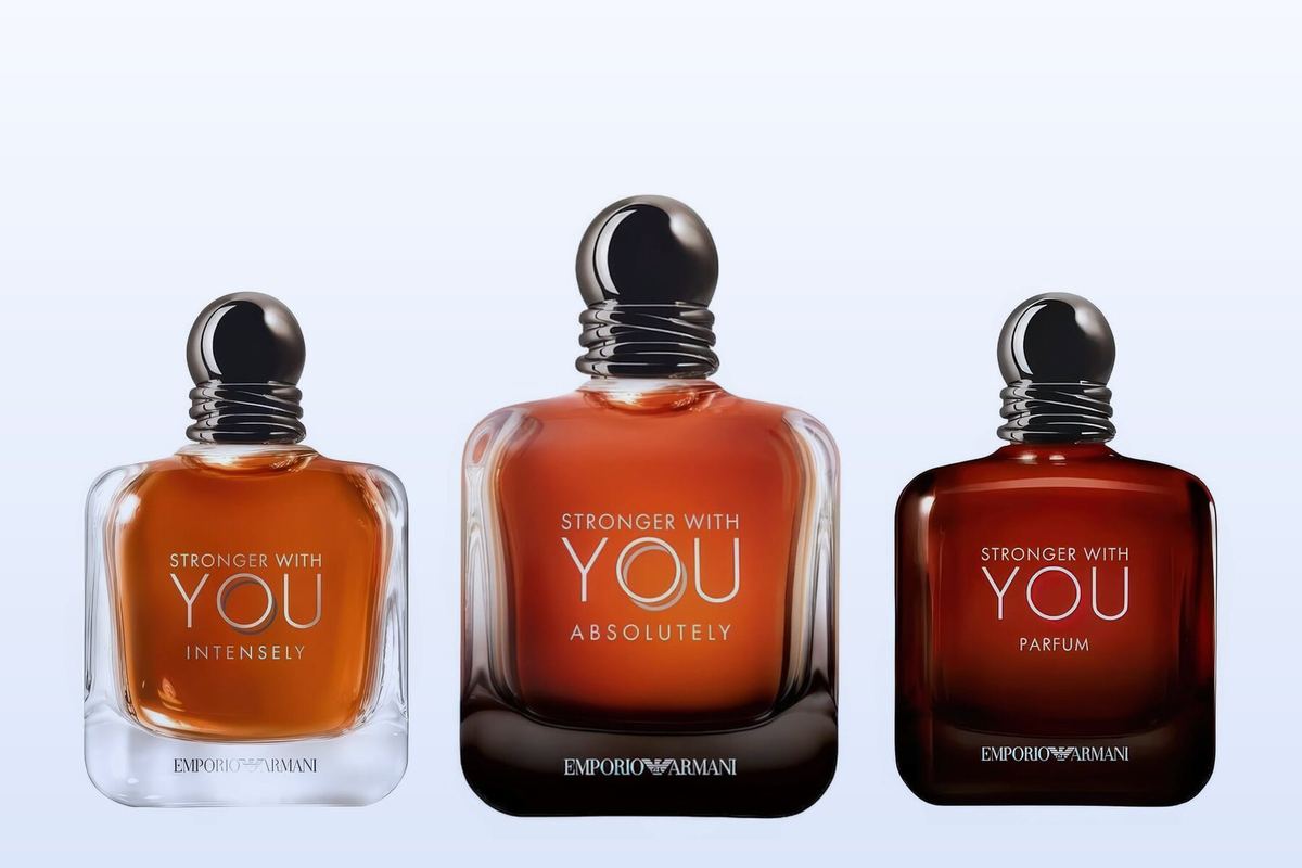 Three Giorgio Armani bottles, Stronger With You Intensely, Stronger With You Absolutely and Stronger With You Parfum, on a pale blue background