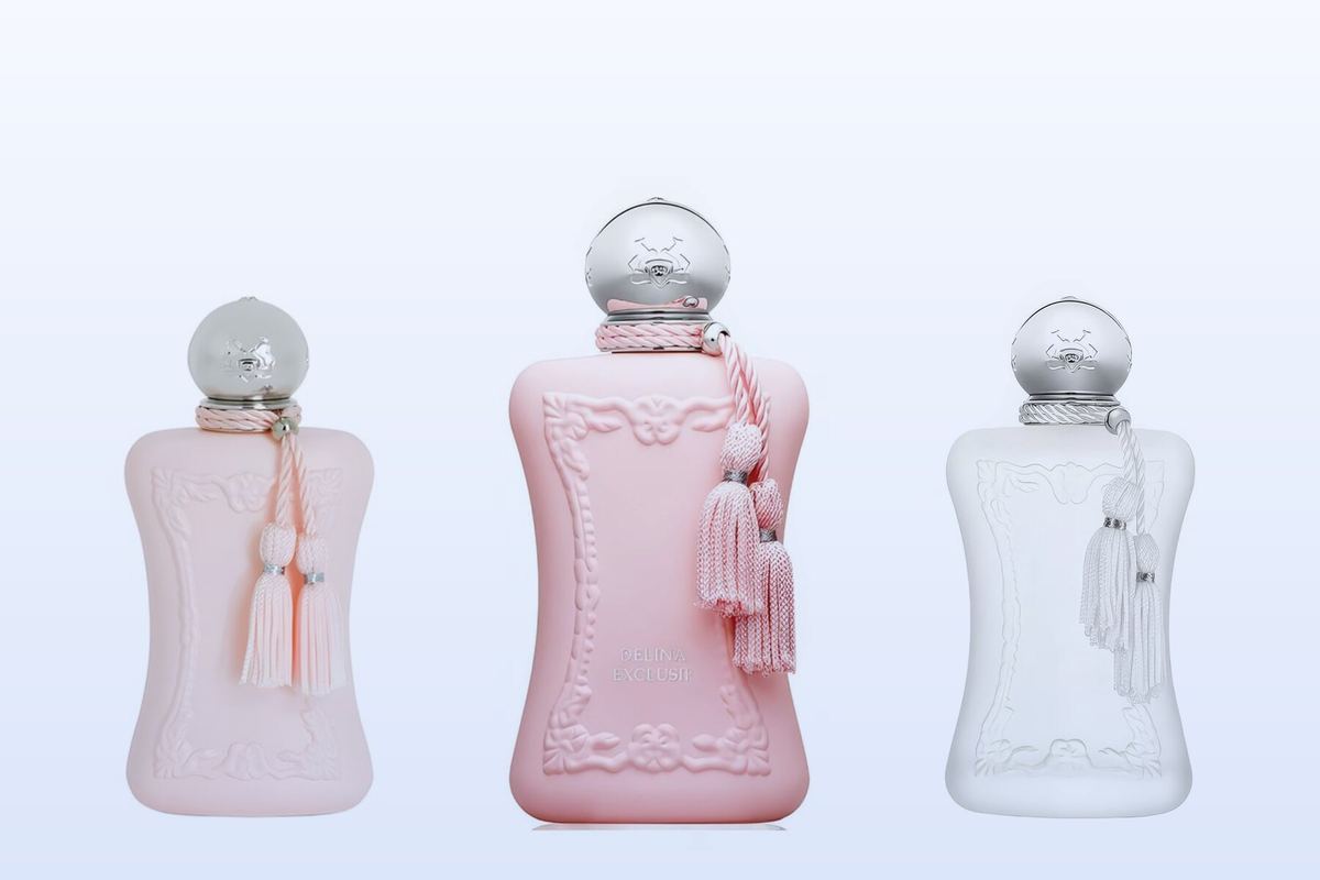 Three Parfums de Marly bottles, Delina, Delina Exclusif and Valaya, on a pale blue background