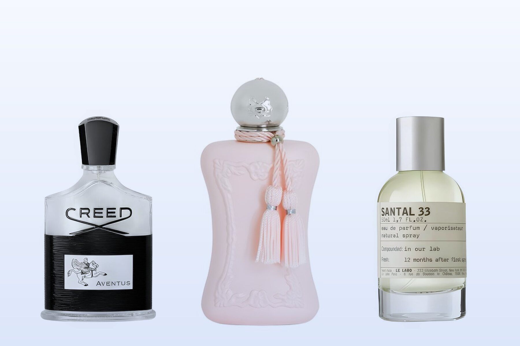 Three fragrance bottles, Aventus by Creed, Delina by Parfums de Marly and Santal 33 by Le Labo, on a pale blue background