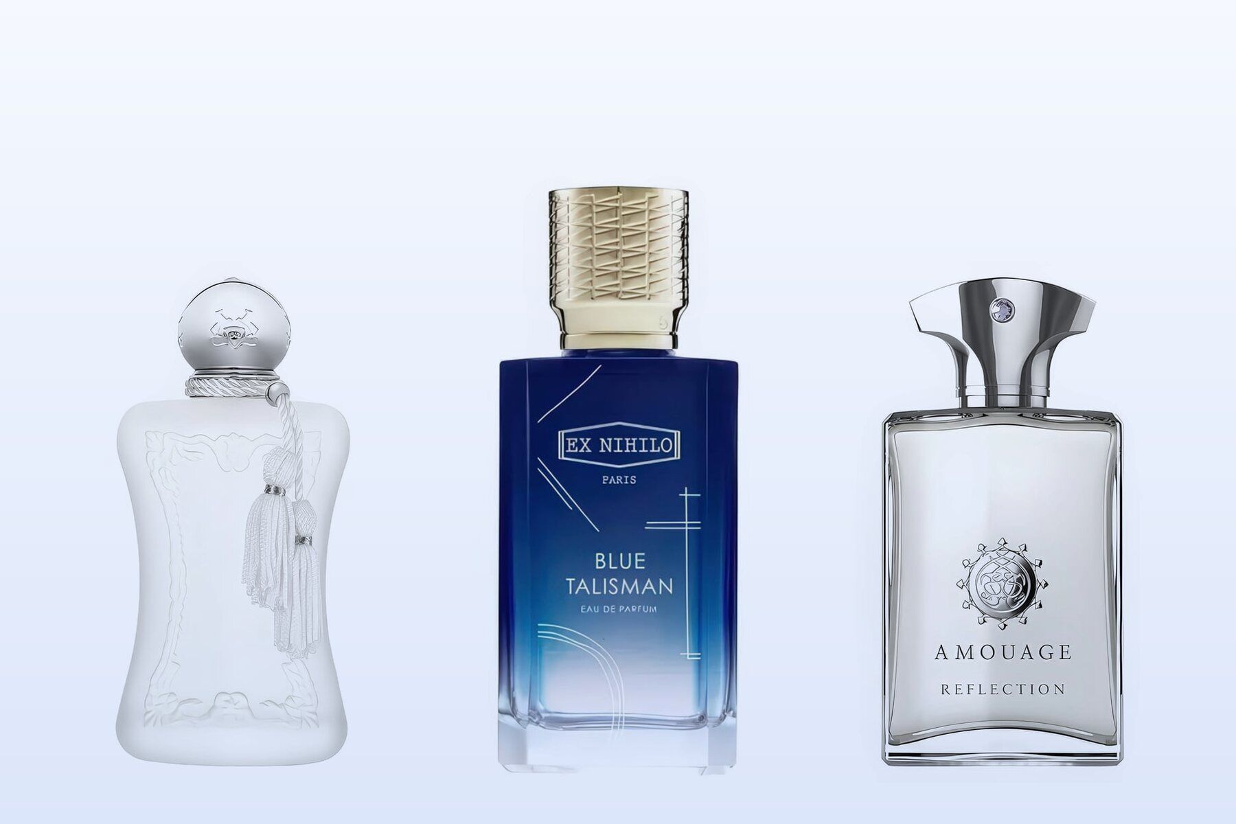 Three fragrance bottles, Valaya, Blue Talisman and Reflection Man, on a pale blue background