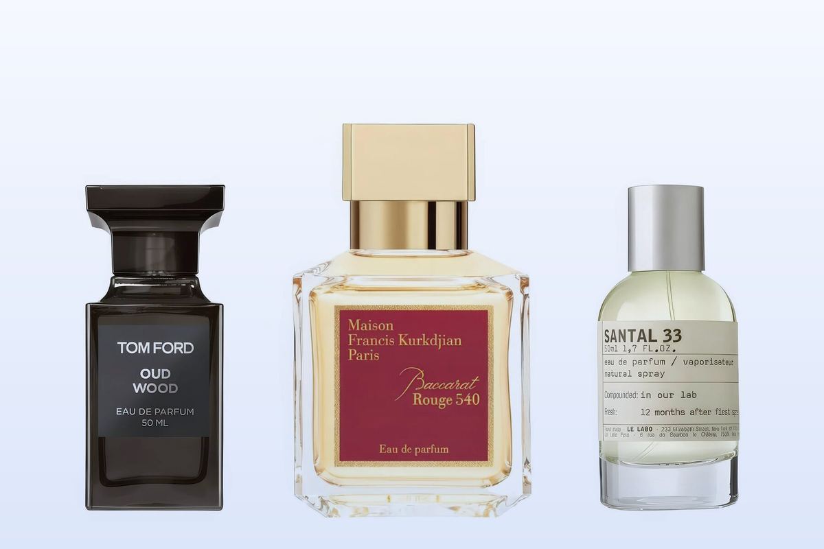 Three fragrance bottles, Oud Wood, Baccarat Rouge 540 and Santal 33, on a pale blue background