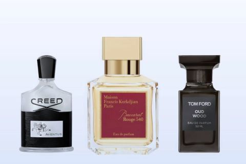 Three fragrance bottles, Aventus, Baccarat Rouge 540 and Oud Wood, on a pale blue background