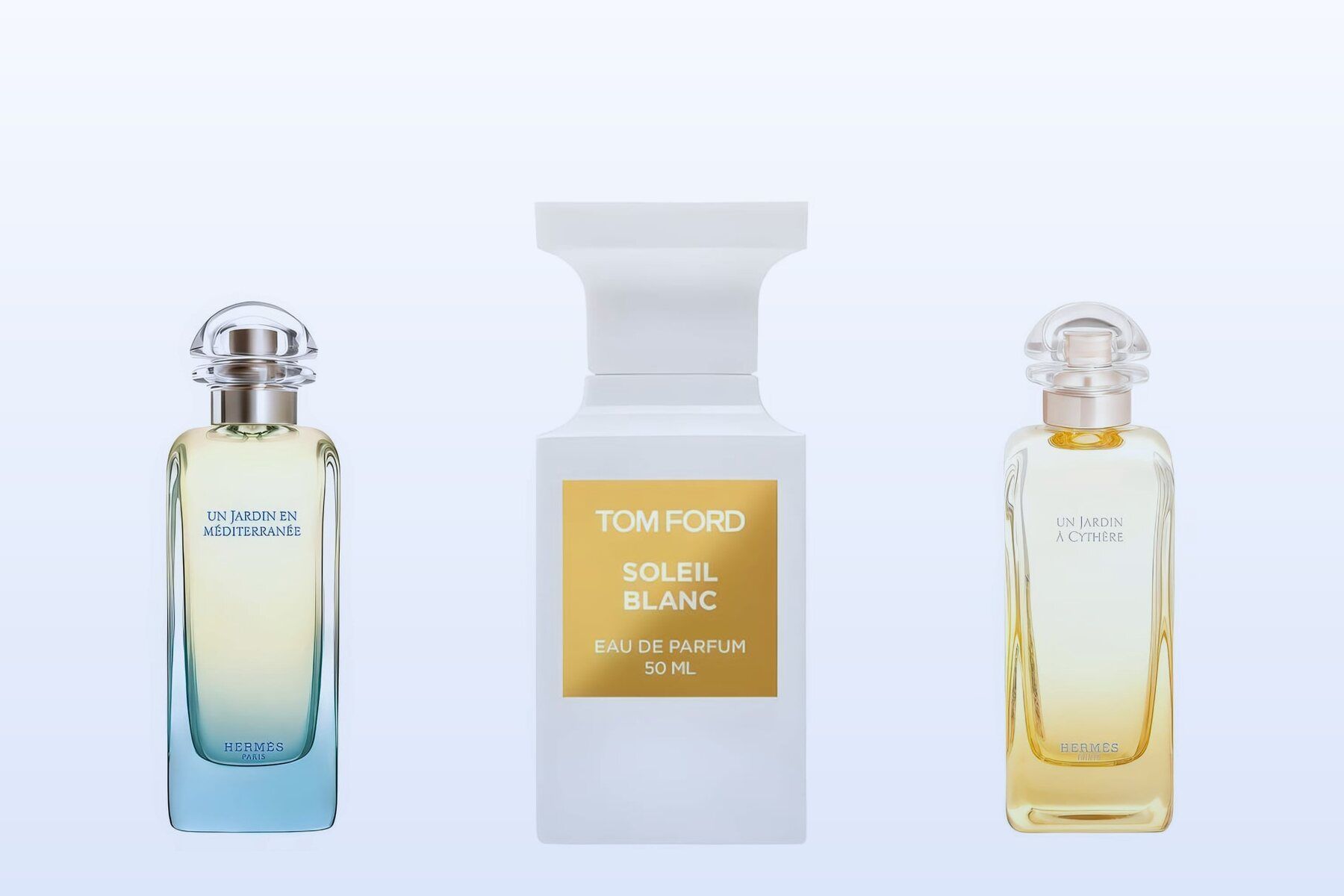 Three fragrance bottles, Un Jardin en Méditerranée, Soleil Blanc and Un Jardin à Cythère, on a pale blue background