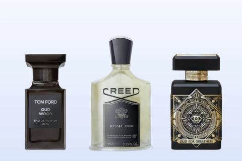 Oud Wood by Tom Ford, Royal Oud by Creed and Oud for Greatness by Initio Parfums Prives on a pale blue background