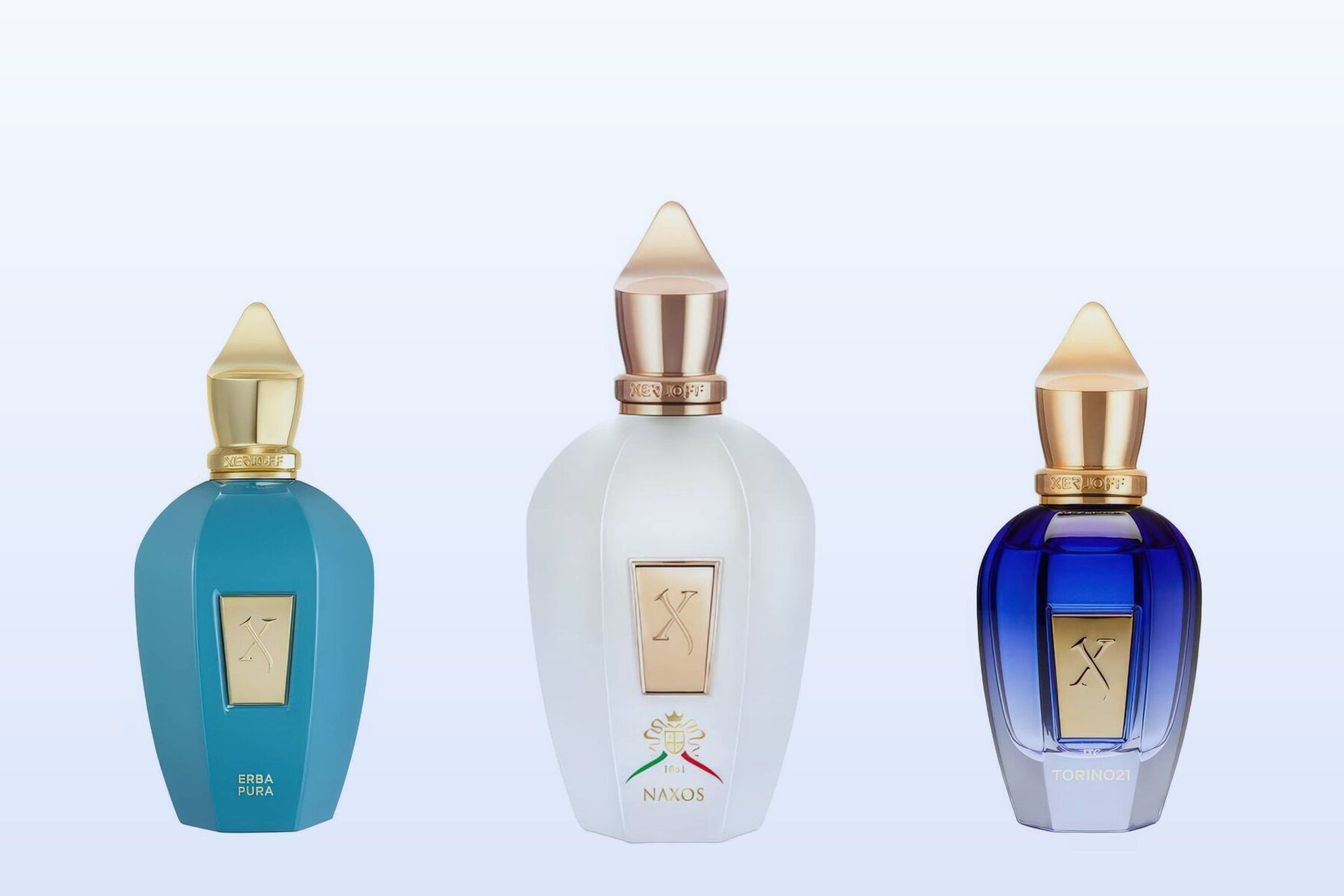 Three Xerjoff bottles, Erba Pura, XJ 1861 Naxos and Torino21, on a pale blue background