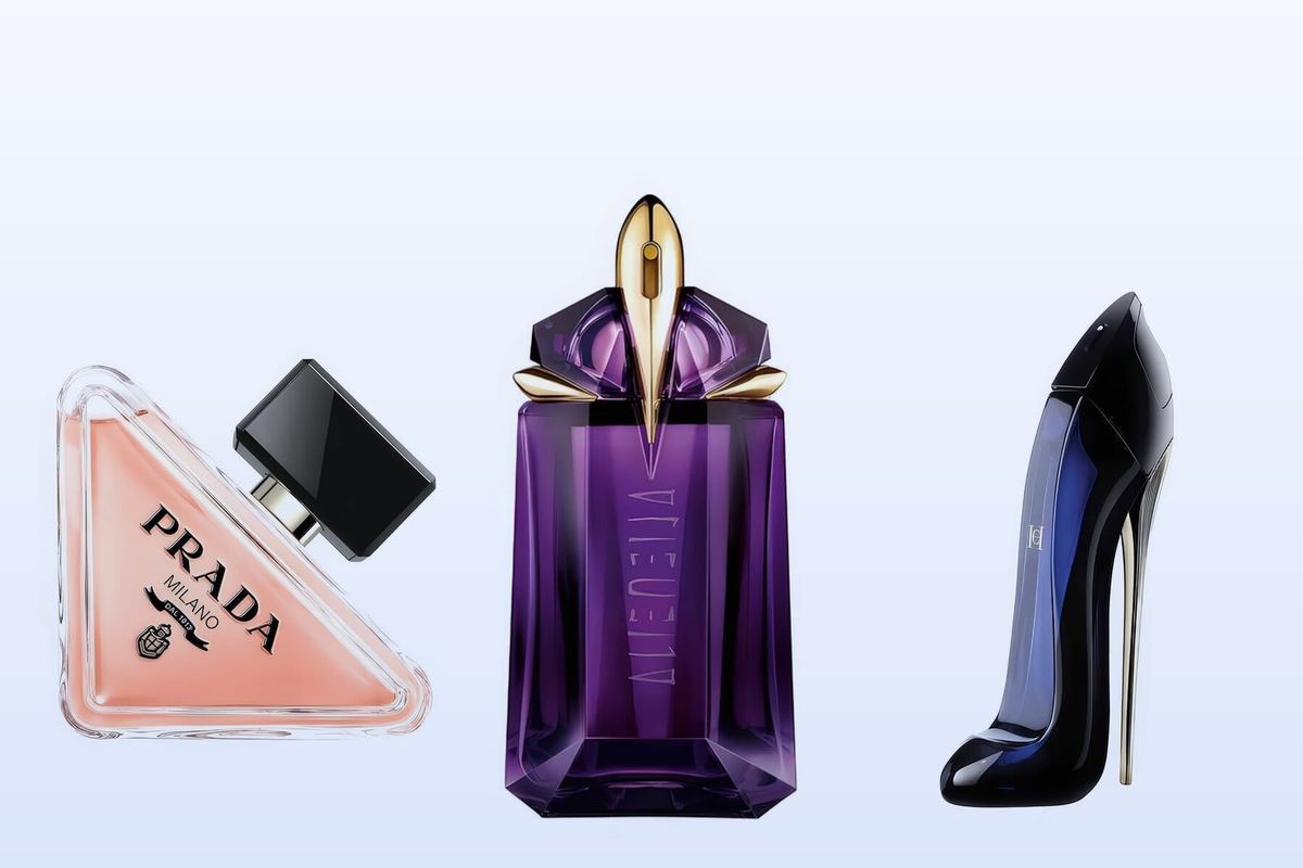 Three bottles on a pale blue background, Prada Paradoxe, Alien by Mugler and Good Girl by Carolina Herrera