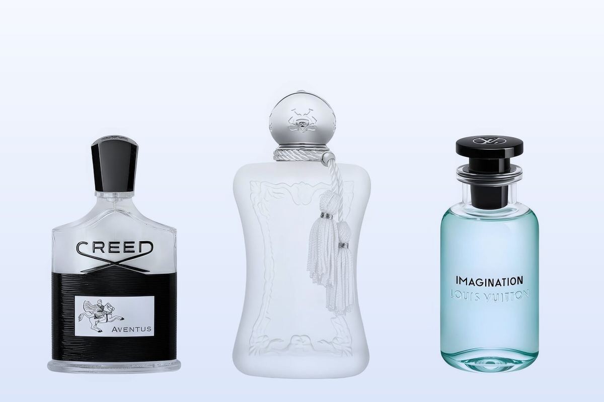 Three fragrance bottles, Aventus, Valaya and Imagination, on a pale blue background