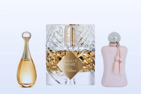 Three fragrance bottles, J'adore, Angels' Share and Delina, on a pale blue background