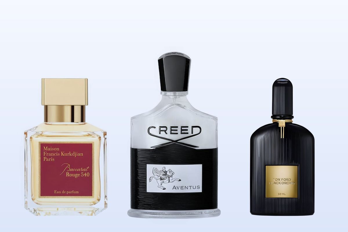 Three bottles, Baccarat Rouge 540 by Maison Francis Kurkdjian, Aventus by Creed and Black Orchid by Tom Ford, on a pale blue background