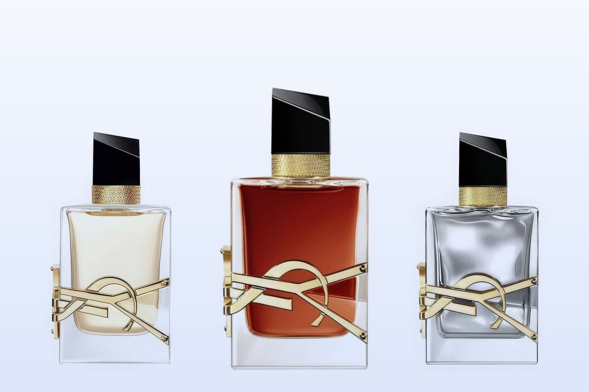 Three fragrance bottles, Libre, Libre Le Parfum and Libre L'Absolu Platine, on a pale blue background