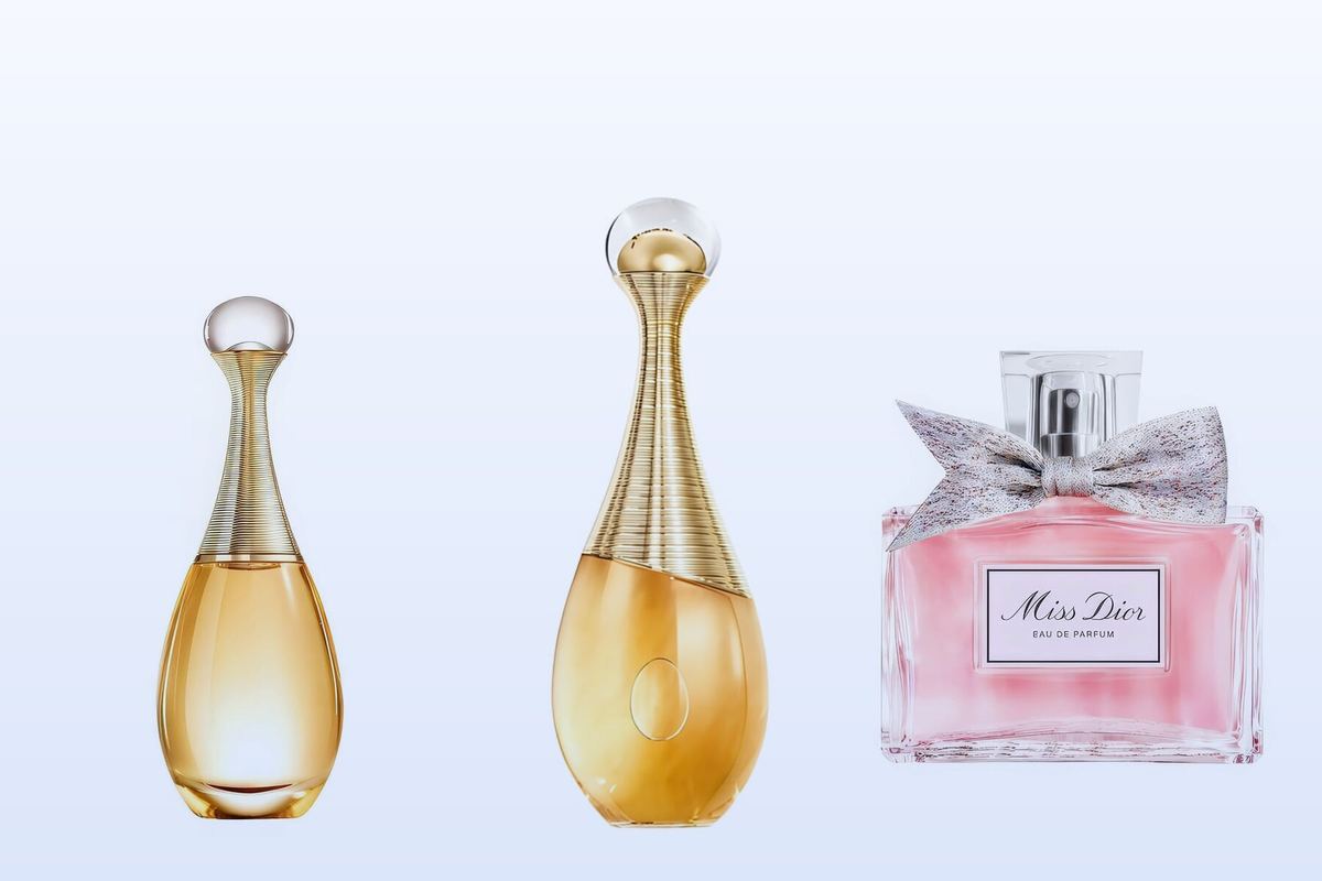 Three Dior bottles, J'adore, J'adore Intense and Miss Dior Eau de Parfum, on a pale blue background