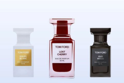 Three bottles on a pale blue background, Soleil Blanc, Lost Cherry and Oud Wood by Tom Ford