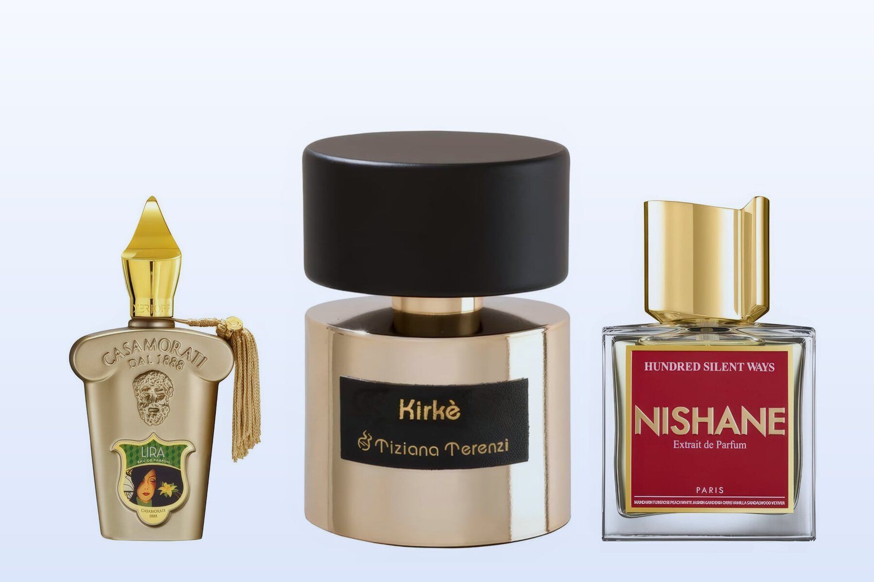 Three bottles, Lira by Xerjoff, Kirke by Tiziana Terenzi and Hundred Silent Ways by Nishane, on a pale blue background