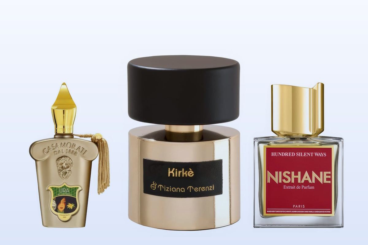 Three bottles, Lira by Xerjoff, Kirke by Tiziana Terenzi and Hundred Silent Ways by Nishane, on a pale blue background