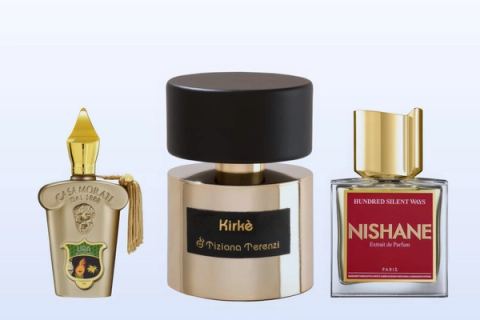 Three bottles, Lira by Xerjoff, Kirke by Tiziana Terenzi and Hundred Silent Ways by Nishane, on a pale blue background