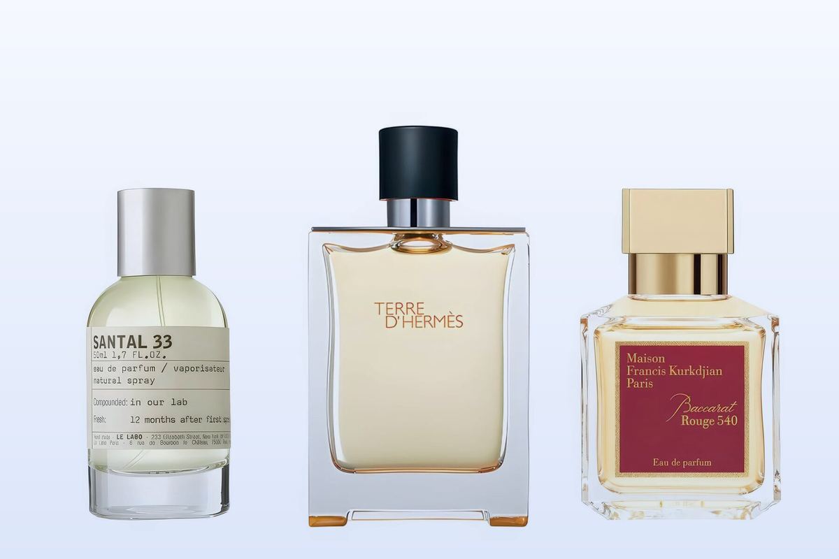 Three fragrance bottles, Santal 33, Terre d'Hermès and Baccarat Rouge 540, on a pale blue background