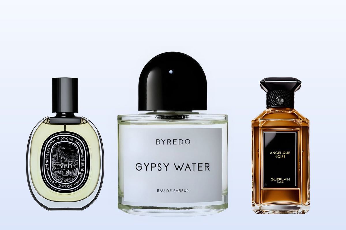 Three bottles on a pale blue background, Eau Duelle by Diptyque, Gypsy Water by Byredo and Angélique Noire by Guerlain