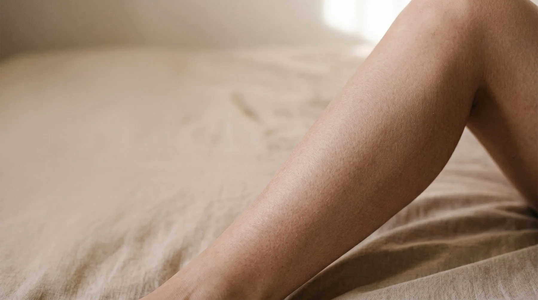 Dry skin on legs — lower legs on a bed