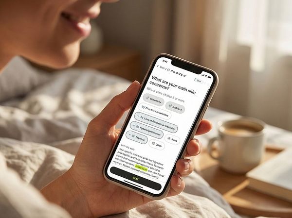 Person lying in bed holding a smartphone displaying the Proven skincare quiz.